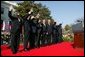 President George W. Bush waves with Prime Ministers of seven countries after a South Lawn ceremony welcoming them into NATO Monday, March 29, 2004. From left are: Prime Minister Indulis Emsis of Latvia, Prime Minister Anton Rop of Slovenia, Prime Minister Algirdas Brazauskas of Lithuania, Prime Minister Mikulas Dzurinda of the Slovak Republic, President George W. Bush, Prime Minister Adrian Nastase of Romania, Prime Minister Simeon Saxe-Coburg Gotha of Bulgaria, Prime Minister Juhan Parts of Estonia, and NATO Secretary General Jaap de Hoop Scheffer.  White House photo by Susan Sterner