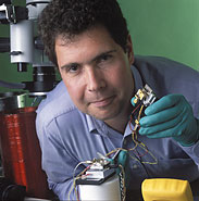 NIST physicist John Kitching with the world’s smallest atomic clock.