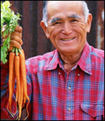 Photo: A man holding fresh carrots
