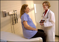 Photo: A healthcare professional consulting with expecting parents.