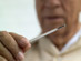 A man reading a thermometer