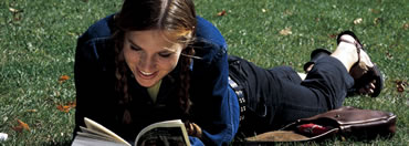 RIT/NTID student reading a book in the quad