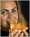 Photo of a woman eating pizza.