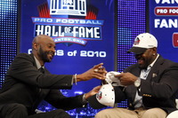 Feb 6, 2010; Fort Lauderdale, FL, USA; Jerry Rice  and Emmitt Smith  swap autographs on each others class of 2010 Pro Football Hall of Fame hats during a new conference after being named to the NFL Hall of Fame class of 2010 at the Fort Lauderdale Convention Center. Mandatory Credit: John David Mercer-US PRESSWIRE