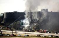 Smoke billows from the building. Austin Mayor Lee Leffingwell said one person remained unaccounted for Thursday afternoon.