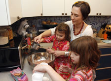 Amy Twomey's daughters Brooklyn, 3, and Mia, 6, help her make a gluten-free chocolate cake.