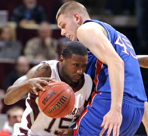 Texas A&M's Donald Sloan tries to get around Kansas' Cole Aldrich, right, during the first half on Monday in College Station. Sloan scored 15 points, but he only had three in the second half.