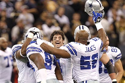 Cowboys players celebrate DeMarcus Ware's (94) sack of Saints quarterback Drew Brees, which resulted in a Dallas fumble recovery and sealed Saturday's upset of previously unbeaten New Orleans.