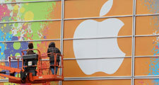Workers apply the Apple logo to the exterior of the  Yerba Buena Center for the Arts in preparation for a  much-anticipated event where CEO Steve Jobs is expected to  unveil a new Apple tablet computer. 