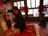 YUSHU, CHINA - DECEMBER 6:  Nineteen-year-old groom Wang Yueming unveils the veil for eighteen-year-old bride Xiao Di in the bridal chamber at the Wangjiacun Village on December 6, 2009 in Yushu of Jilin Province, China. Wang and Xiao are farmers from the village. Usually in the wedding customs...