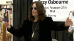 Ozzy Osbourne signs books for fans