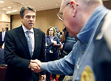 Texas Gov. Rick Perry (left) greets Ray Neely, 66, of Pasedena during a Feburary campaign stop in Mesquite.