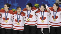 Canada players sing the national anthem after Canada beat USA 2-0 to win the women's gold medal ice hockey game at the Vancouver 2010 Olympics in Vancouver, British Columbia, Thursday, Feb. 25, 2010. (AP Photo/Chris O'Meara)