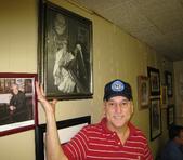 Clovis Cisneros, owner of Cisco's Bakery & Bar, shows a photo of his dad, Rudy 'Cisco' Cisneros, humorously garbed as 'The Restaurateurs' Guardian Angel.' Clovis Cisneros has worked at the East Austin staple since he was 8. 'I didn't get to go on trips like the other kids did,' he said.