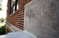 the cornerstone at Adamson High School is dated 1915. Members of the Building Preservation Committee of the Adamson Alumni Association favor a renovation of the historical building rather than building a replacement at the site. (John F. Rhodes / The Dallas Morning News)