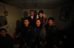 YUSHU, CHINA - DECEMBER 6:  Nineteen-year-old groom Wang Yueming and eighteen-year-old bride Xiao Di pose for pictures with families during their wedding ceremony at the Wangjiacun Village on December 6, 2009 in Yushu of Jilin Province, China. Wang and Xiao are farmers from the village. Usually...