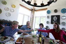 Left to right, Hedda Dowd, co-owner of Dallas restaurant Rise No. 1, co-owner/executive chef Cherif Brahmi, Hedda's son Andre Dowd and Cherif's daughter Tara Brahmi sit down to a meal at Dowd's farm house in Lone Oak, Texas, Sunday July 12, 2009. 