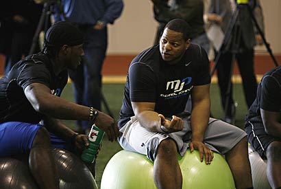 Former Texas star Sergio Kindle (left) and ex-Nebraska defensive tackle Ndamukong Suh (right) chat before having their performance evaluated.