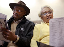 Floyd Smith and his wife, Helen, look over their ballots before casting their votes at a Democratic Party primary voting precinct at R. L. Thornton Elementary School