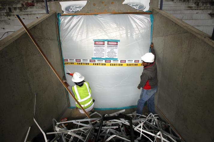 Plastic sheeting is secured in a Texas Stadium tunnel so crews can remove asbestos from the concrete surfaces.