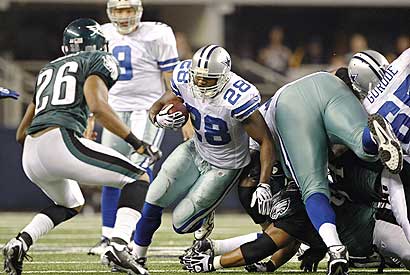 Dallas Cowboys running back Felix Jones (28) breaks through the line during Dallas' 24-0 win over the Philadelphia Eagles on Sunday.