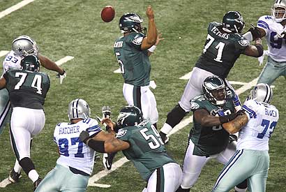 The Dallas defense rushes Eagles quarterback Donovan McNabb during Sunday's game.