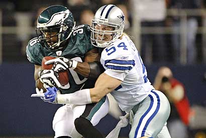 Dallas Cowboys linebacker Bobby Carpenter stops Philadelphia Eagles running back Brian Westbrook in Sunday's game.