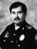 FILE - In this undated photo provided by the The Dallas Police Department shows Dallas police Sr. Cpl. Victor Lozada-Tirado. The 49-year-old officer died, Feb. 22, 2008, after a crash while escorting then-presidential candidate U.S. Sen. Hillary Rodham Clinton's motorcade to a campaign rally...