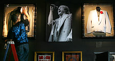 A worker polishes memorabilia displays on the walls of the new Hard Rock Café in Dallas' Victory Park develoment.