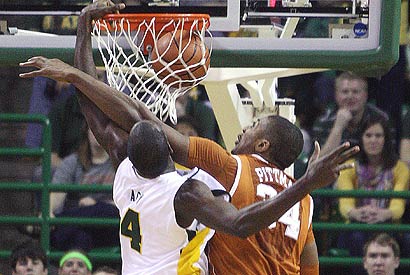 Baylor's Quincy Acy (4) dunks over Texas center Dexter Pittman.