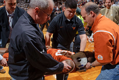 Texas' J'Covan Brown is carried from the court after getting injured during the second half of an NCAA basketball game against Texas A&M on Saturday, Feb. 27, 2010 in College Station, Texas.