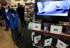 Alex Dickey, 12, of Dallas checks out Green Play digital media players for sale at Blockbuster at Preston and Royal in North Dallas. Patrons can download movies on a memory card to take home to watch on TV with the players. 