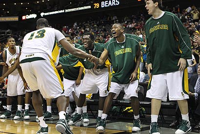 Baylor's Ekpe Udoh (13) celebrates with the Bears' bench after scoring a basket and drawing a foul.