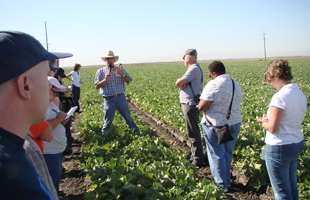 Speaker on a farm with journalists