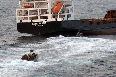 GULF OF ADEN - Marines assigned to the 15th Marine Expeditionary Unit, Maritime Raid Force, approach the motor vessel Magellan Star Thursday, Sept. 9 to recover it from suspected pirates. The Marines boarded the vessel and took nine suspected pirates into custody. The pirates were taken to the guided-missile cruiser USS Princeton (CG 59) and the ship
