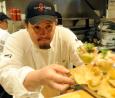 Sous chef Mark Segura sends out an order at Rick Bayless' Topolobampo restaurant in Chicago.