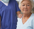 elder patient with nurse hand on shoulder