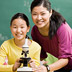 Photo of a teacher and student with a microscope