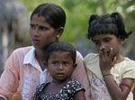 Date: 11/12/2009 Description: This Nov. 12, 2009 photo shows a mother holding her two daughters in her village in Batticaloa, about 143 miles north east of Colombo, Sri Lanka. © AP Image