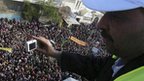 An Arab League monitor watches an anti-Assad rally in Idlib, 31 December