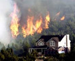 Fire burning behind a house