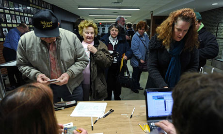 Voters register to cast their ballots during republican caucues at a school  in Des Moines, Iowa.