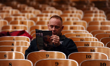 Iowa voter reads a Ron Paul campaign booklet