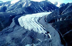 Lateral and terminal moraines of a valley glacier, Bylot Island, Canada. The glacier formed a massive sharp-crested lateral moraine at the  maximum of its expansion during the Little Ice Age. The more rounded terminal moraine at the front consists of medial moraines that were created by the junction of tributary glaciers upstream. (Photo courtesy of the Natural Resources Canada. Copyright Terrain Sciences Division, Geological Survey of Canada.)