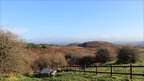 Sunny skies in background, picnic table in the foreground