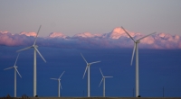 Six wind turbines in a field, with stratocumulous in the background