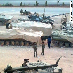 A picture released by the Local Coordination Committees in Syria shows troops taking position in Homs on January 19, 2012 .