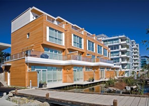 Townhouses face the waterfront at the Dockside Green residential development in Victoria, British Columbia, Canada, on July 12, 2008. The 26-building, 1.3-million-square-foot (120,000-square-meter) project will feature a heating plant fed by waste wood chips, and is aiming to achieve a LEED platinum award from the Canada Green Building Council. Photographer: Enrico Dagostini/Busby Perkins + Will via Bloomberg News  EDITOR'S NOTE: NO SALES. EDITORIAL USE ONLY.   