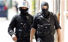 French Police officers cordon off the street where a man claiming to be a member of al-Qaeda who took four hostages in a bank, in toulouse