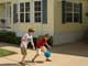 Children playing basketball in the driveway of a mobile home - The AARP® Mobile Home Insurance Program from Foremost Group